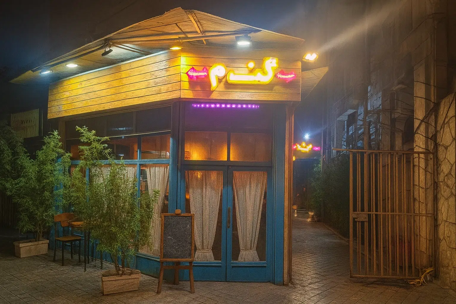 فضای دنج و آرام کافه گندم رشت با میزهای چوبی و نور ملایم